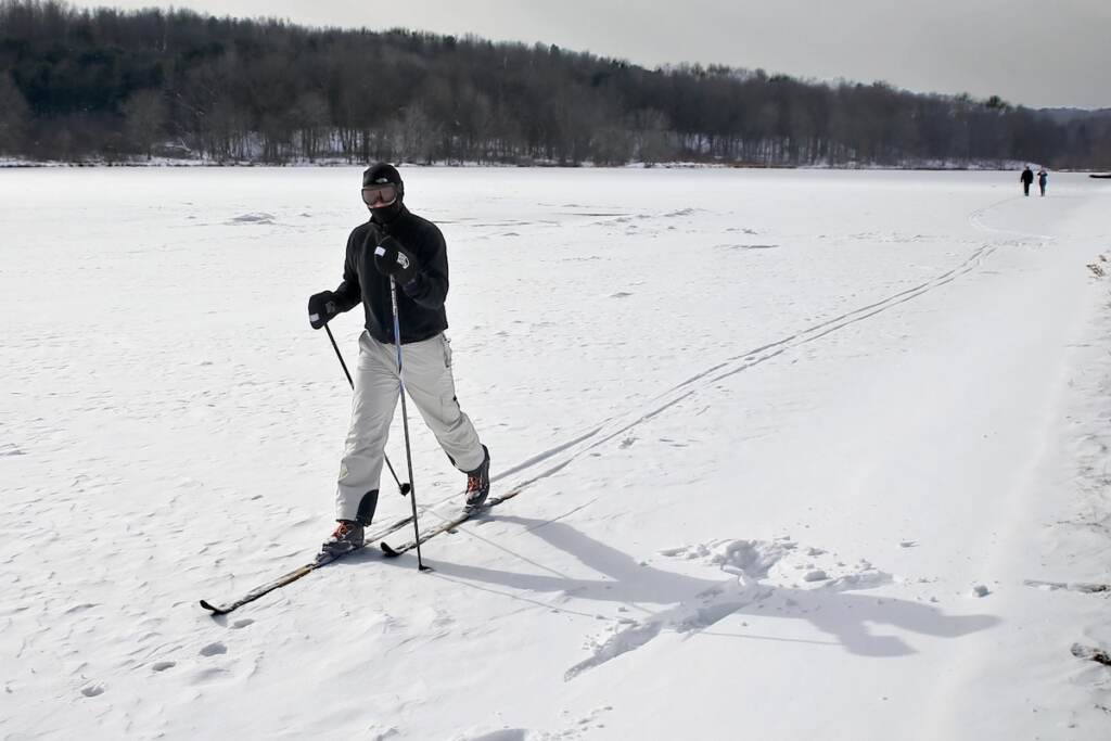 first-day-hike-pa copy A man skis in an open, snow-covered field.