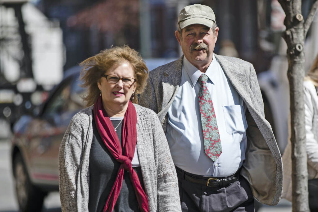 Police Barracks Ambush FILE – Deborah Frein, left, and Eugene Michael Frein, right, the parents of Eric Frein, walk to the Chester County Justice Center in West Chester, Pa., March 9, 2017. The parents of gunman Eric Frein, who killed a Pennsylvania state trooper and permanently disabled another eight years ago in an ambush of a police barracks, have settled a lawsuit that accused them of partial responsibility for the attack. A Lackawanna County judge was to hear arguments on the motion Oct. 31, 2022, but court documents indicate that he was advised that the case had been settled, the Wilkes-Barre Citizens' Voice reported. (AP Photo/Matt Rourke, File)