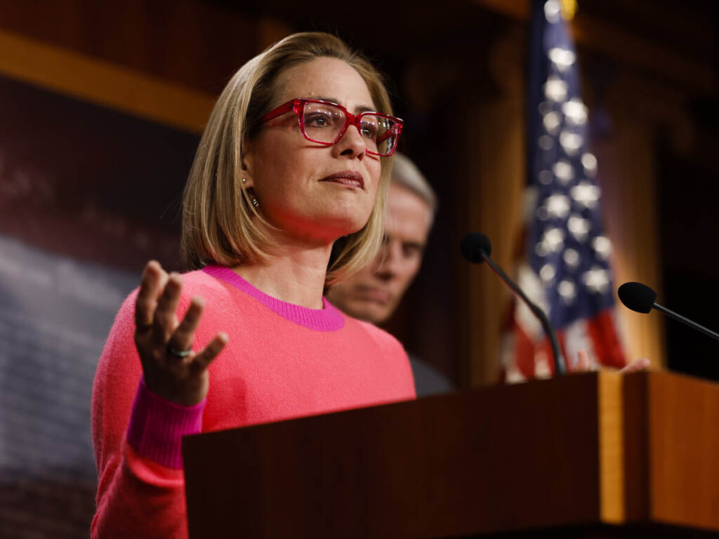 U.S. Sen. Kyrtsen Sinema speaks from a podium