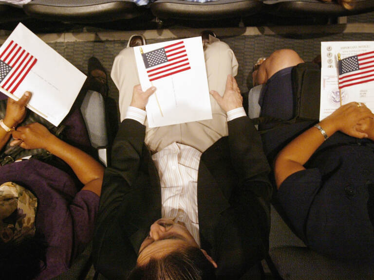 People hold the U.S. flag in their lap.