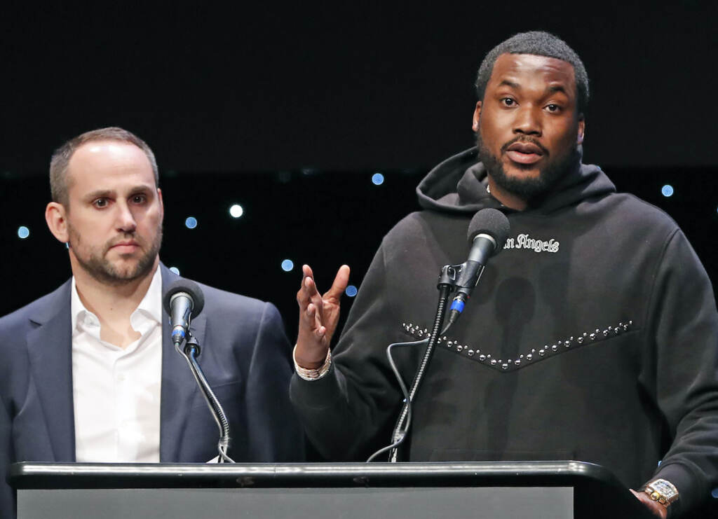 Michael Rubin, Meek Mill FILE - Musician Meek Mill, right, speaks about his incarceration along with Philadelphia 76ers co-owner Michael Rubin at the launch of REFORM Alliance in New York on Jan. 23, 2019. The pair shared laughs Tuesday, Dec. 13, 2022, at an outing meant to brighten the day for kids from families caught in the criminal justice system. (AP Photo/Kathy Willens, File)