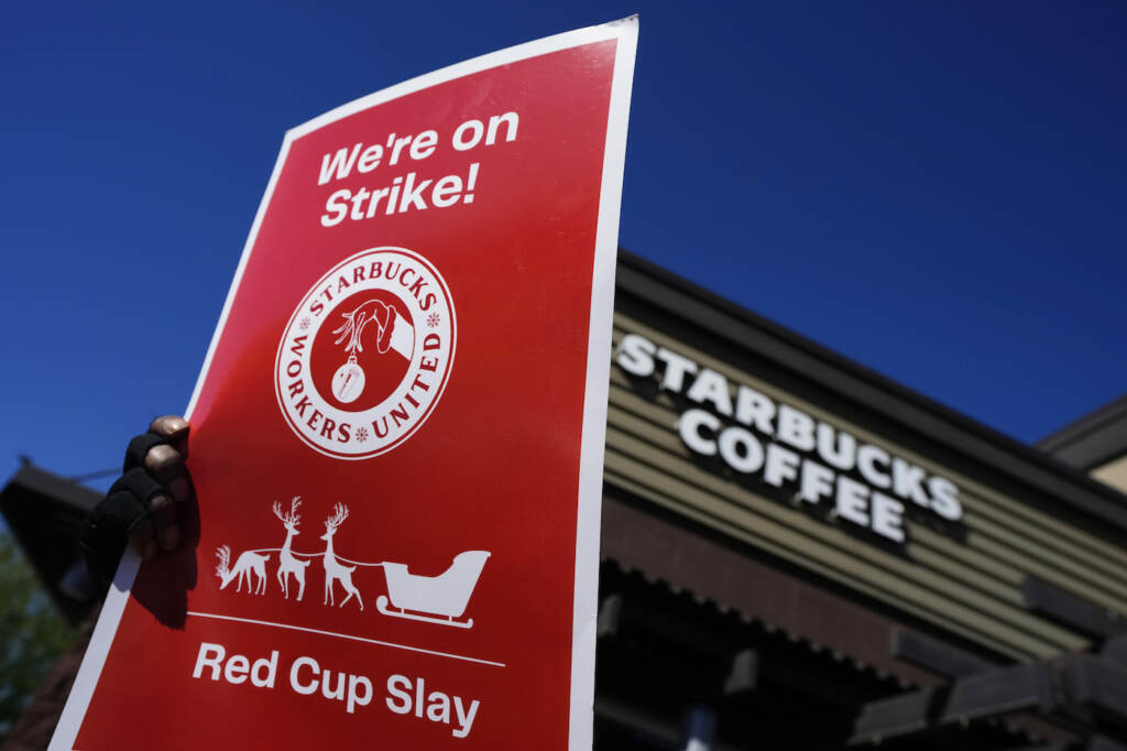 Starbucks Strike FILE - Starbucks employees strike outside their store in Mesa, Ariz., Nov. 17, 2022. Starbucks workers around the U.S. are planning a three-day strike starting Friday, Dec. 16, as part of their effort to unionize the coffee chain's stores. (AP Photo/Matt York, File)