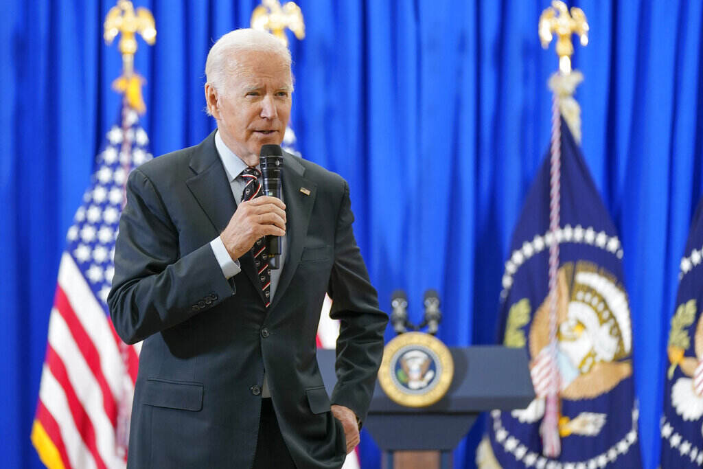 Biden President Joe Biden speaks into a microphone.