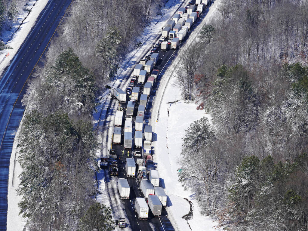 APTOPIX Winter Weather Interstate Shutdown Drivers wait for the traffic to be cleared as cars and trucks are stranded on sections of I-95 after a snow storm.