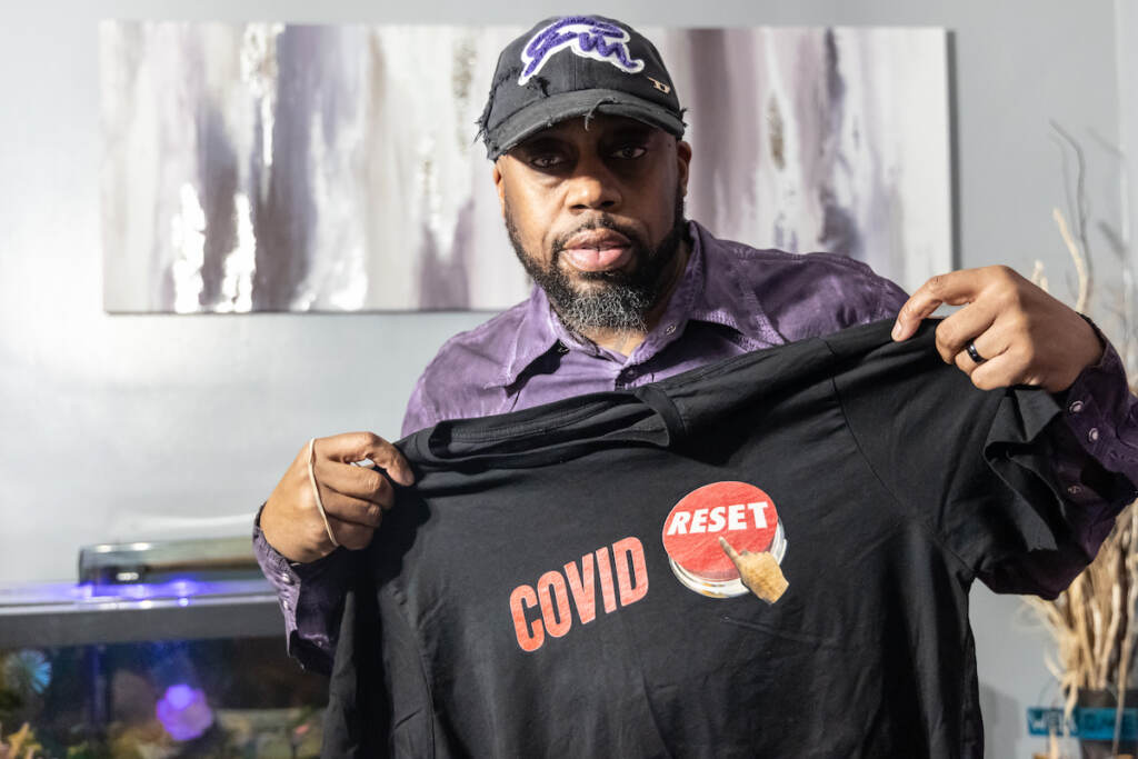 01 04 2023 k paynter george mink jr. healthcare delco-3 George Mink Jr. shows his COVID Reset t-shirt at his home in Delaware County, Pa