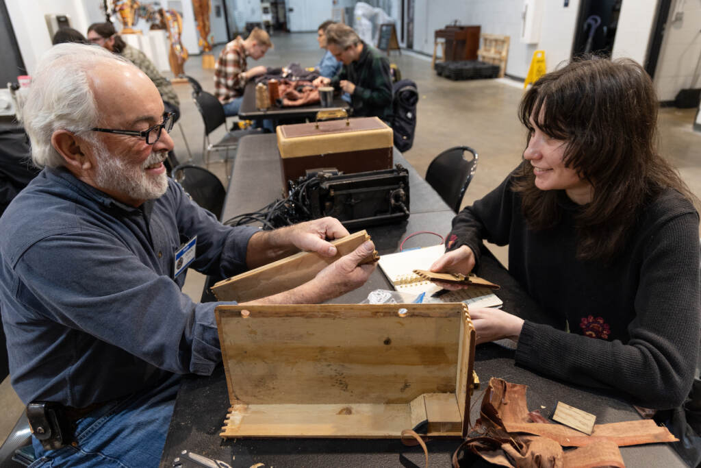 01 18 2023 k paynter leigh hilford and john everett philly fixers guild repair fair_ A volunteer (left) helps Leigh Hilford fix a sewing machine