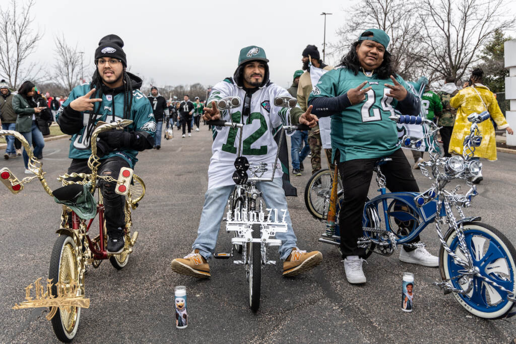 01 29 2023 k paynter fans general-3 Fan Pedro Cartahgena (left), Victor River (center) and Mauricio Vasquez (right) support the Philadelphia Eagles from the tailgate outside the Linc during the NFC East Championship Game on January 29, 2023. (Kimberly Paynter/WHYY)