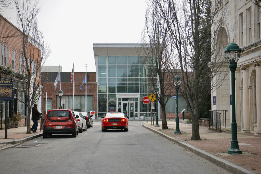 Chester City Hall at East 4th Street and Avenue of the States. (Emma :ee/WHYY) Chester City Hall is visible at the end of a road lined with buildings.