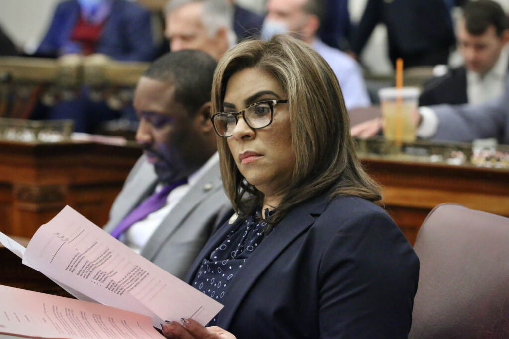 Philadelphia City Council Member Quetcy Lozado. (Emma Lee/WHYY) Councilmember Lozada reviews papers while seated at her desk in council chambers.
