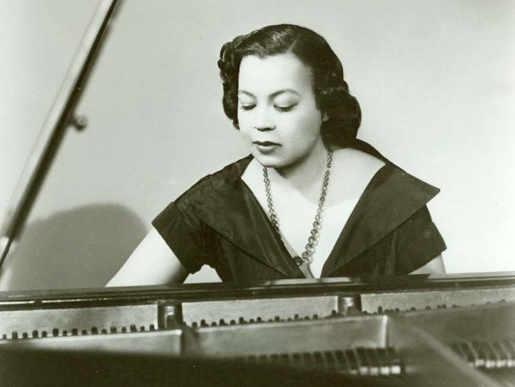 Composer Margaret Bonds (Courtesy of Opera Philadelphia) Margaret Bond seated at the piano in a black-and-white photograph.