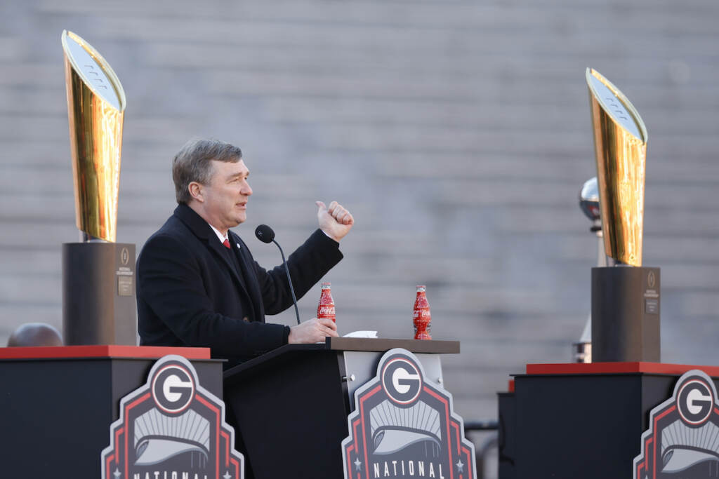 Georgia head coach Kirby Smart speaks while standing between the 2022 and 2023 championship trophies during a ceremony celebrating the Bulldog's second consecutive NCAA college football national championship, Saturday, Jan. 14, 2023, in Athens, Ga.