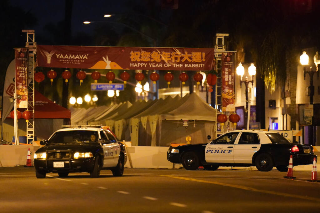 California Shooting Two police vehicles are seen near a building where a shooting occurred in Monterey Park, Calif.