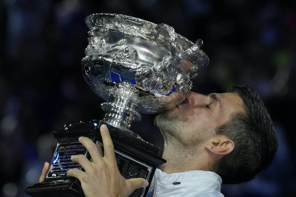 Novak Djokovic of Serbia kisses the Norman Brookes Challenge Cup after defeating Stefanos Tsitsipas of Greece in the men's singles final at the Australian Open