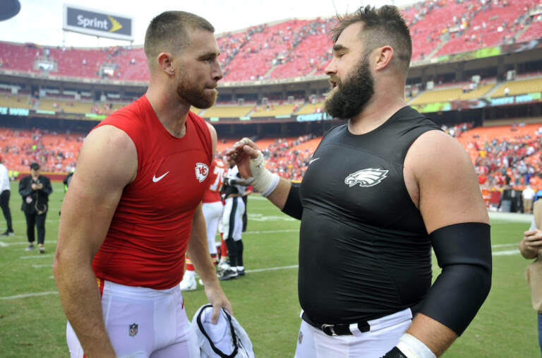 Kansas City Chiefs tight end Travis Kelce, left, talks to his brother, Philadelphia Eagles center Jason Kelce, after they exchanged jerseys following an NFL football game in Kansas City, Mo.