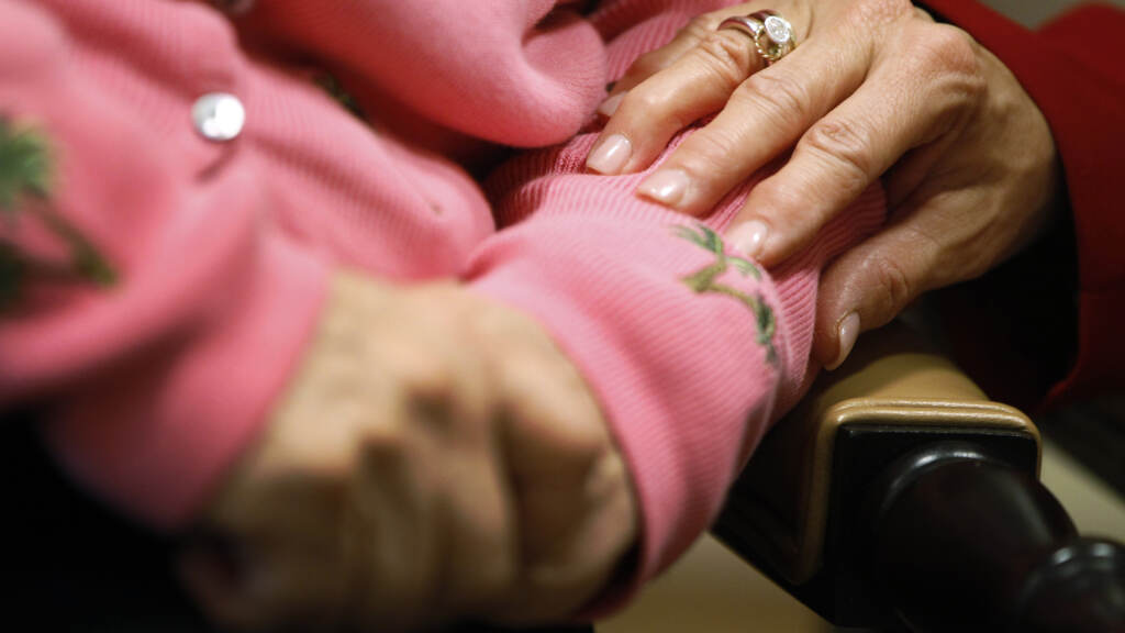 Older people who have few social connections and interactions are at a higher risk for developing dementia, a new study has found. An upclose shot of two people holding hands.