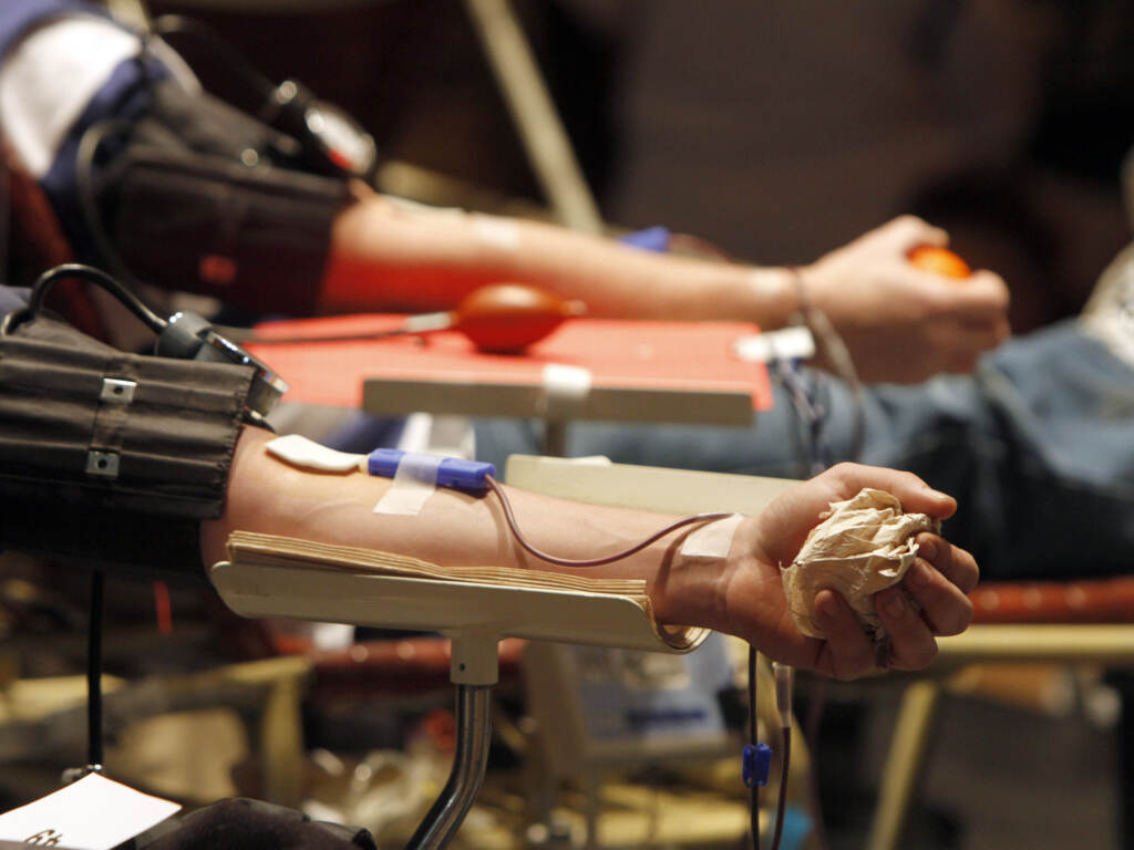 People giving blood at a blood drive.