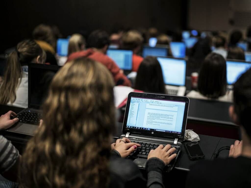 FRANCE-EDUCATION-UNIVERSITY Students look at their laptops in a classroom.