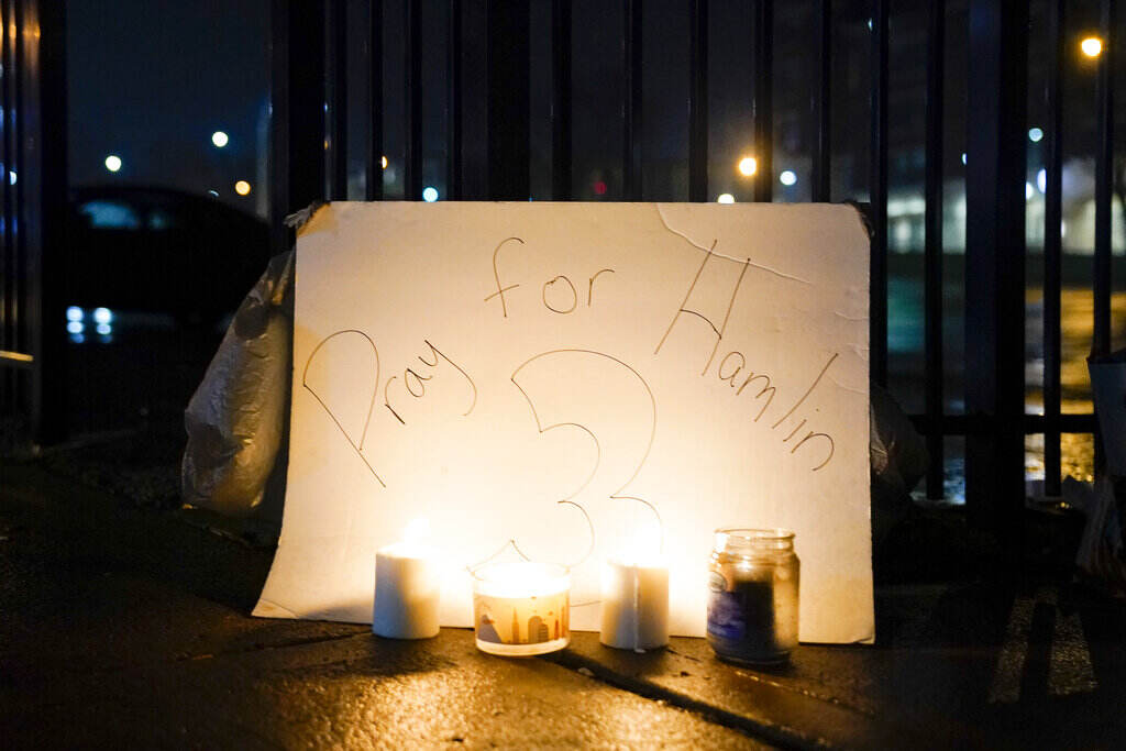 Bills Bengals Hamlin Football Candles are placed in front of a sign that reads