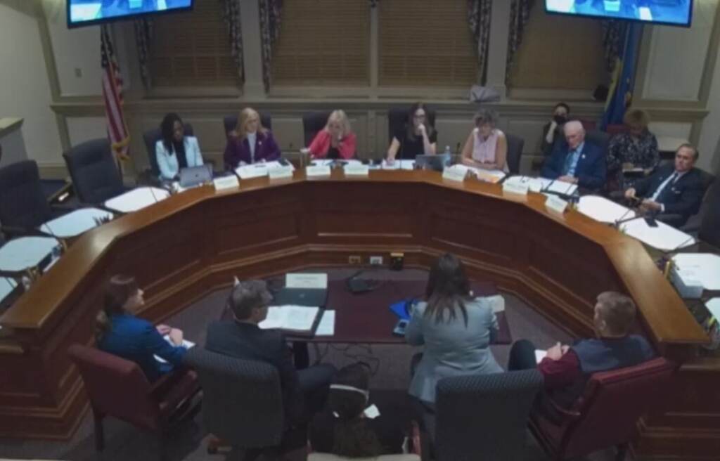 An aerial view of a group of people in a hearing.