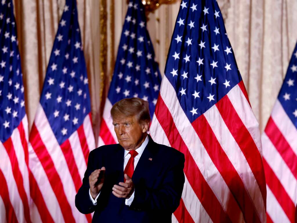 Suspending former President Donald Trump’s account was the most high-profile and controversial content moderation decision Facebook parent Meta has ever made. Donald Trump claps in front of a row of American flags.