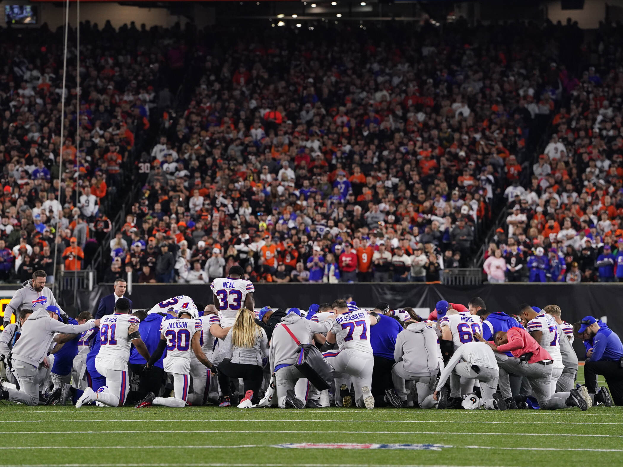 Buffalo Bills players huddle and pray after teammate Damar Hamlin collapsed on the field after making a tackle against the Cincinnati Bengals during the first quarter at Paycor Stadium on Monday in Cincinnati, Ohio. Buffalo Bills players huddle and pray after teammate Damar Hamlin collapsed on the field after making a tackle against the Cincinnati Bengals during the first quarter at Paycor Stadium on Monday in Cincinnati, Ohio. (Dylan Buell/Getty Images)
