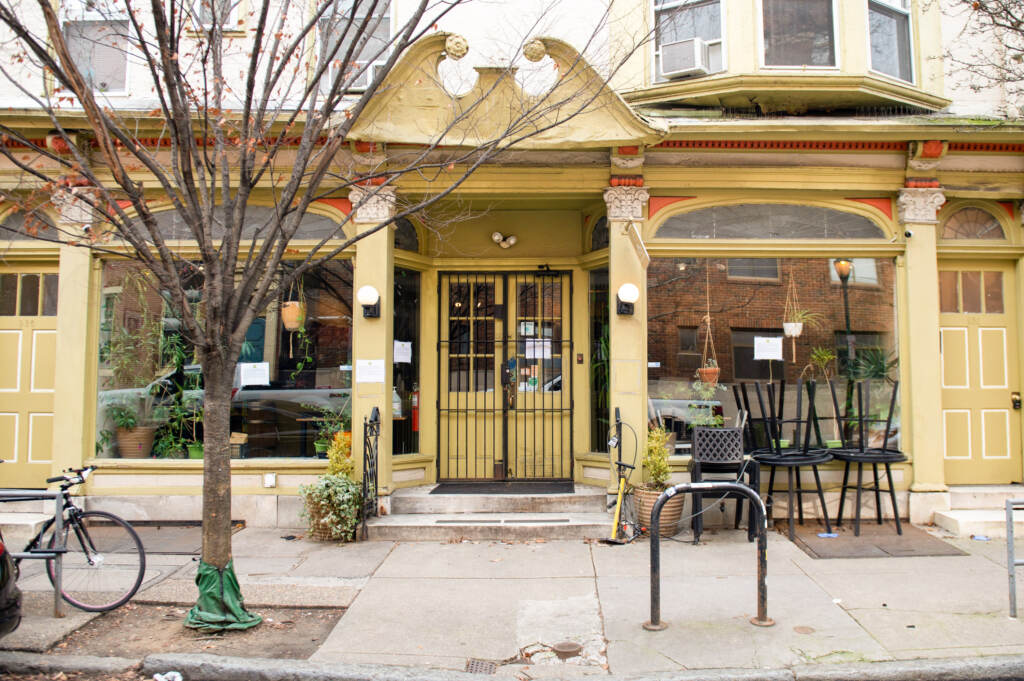 Good Karma Cafe on 928 Pine St. in Philadelphia with signs announcing the location’s immediate and indefinite closure due to embezzlement pictured on Tuesday, Jan. 10, 2023. (Erin Blewett for Billy Penn)