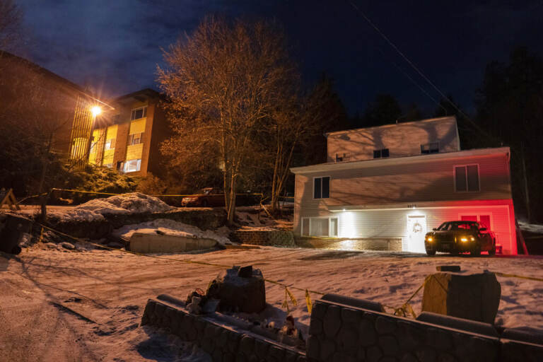 A house is visible with security surrounding it.