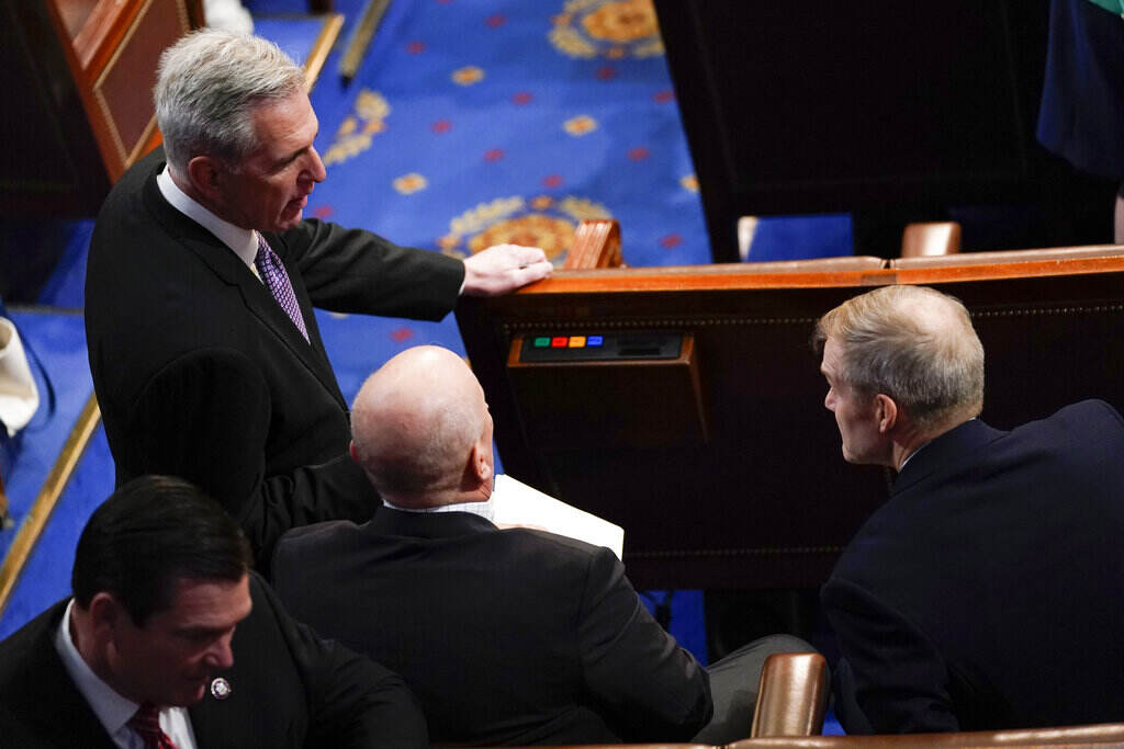Congress McCarthy stands with a group of people on the House floor.