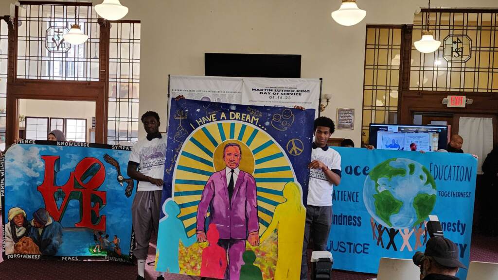 Students unveil the mural of Dr. Martin Luther King. (Tom MacDonald/WHYY)