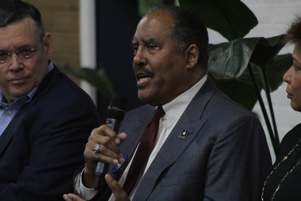 James "Jimmy" DeLeon holds up a microphone at a Philly mayoral candidate forum