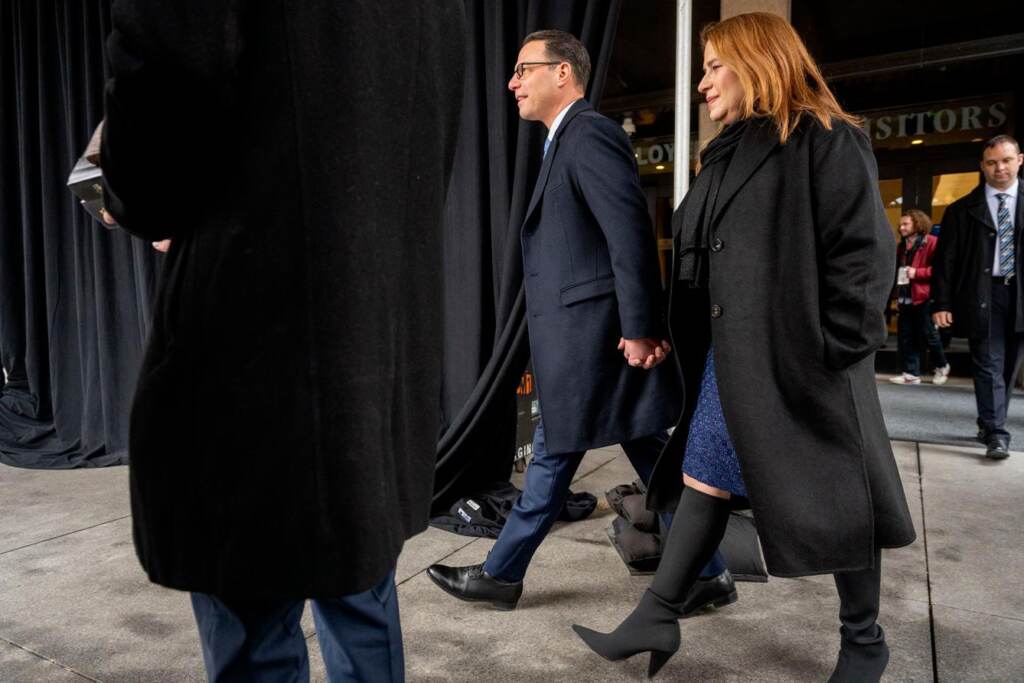 Shapiro walks hand in hand with his wife.