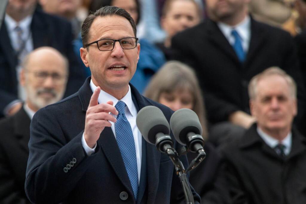 Josh Shapiro speaks into a microphone at his gubernatorial inauguration.