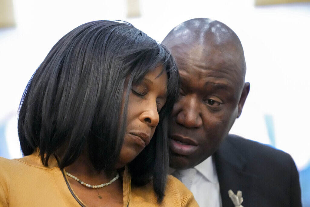 A woman is comforted by a man standing next to her.