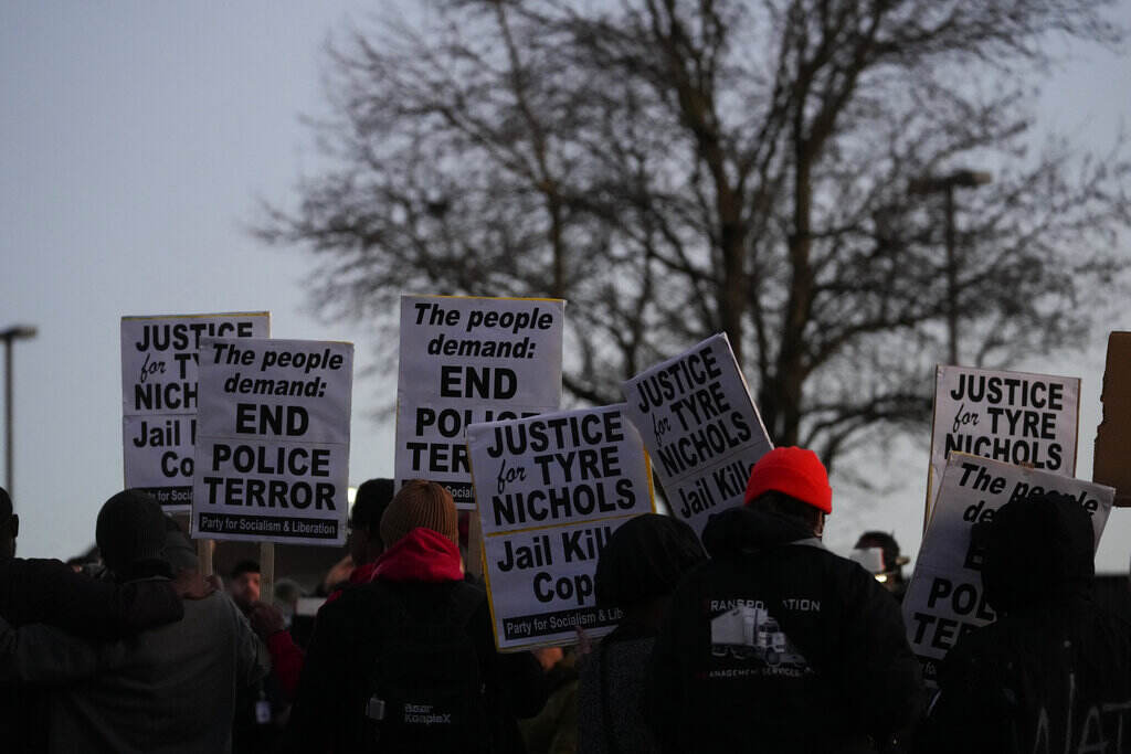 APTOPIX Memphis Police Force Investigation People hold up signs protesting the police killing of Tyre Nichols.