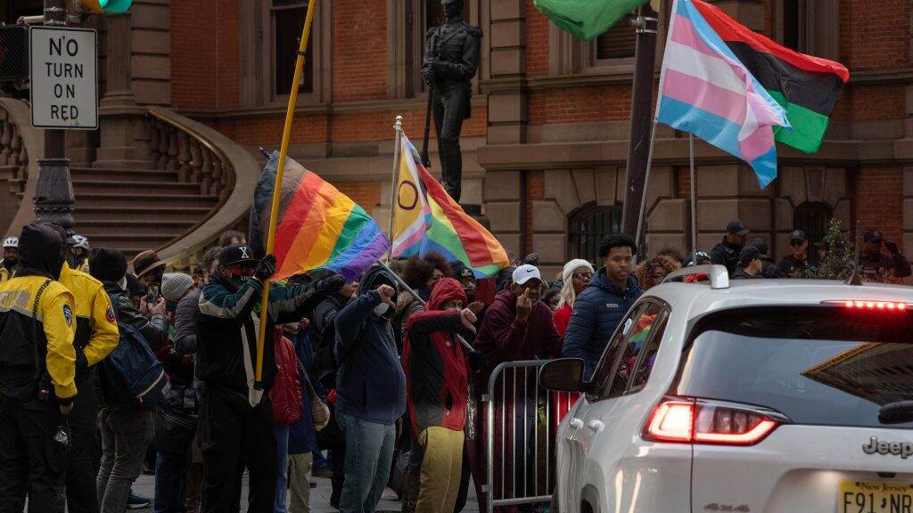 unionleague-desantisprotest-05b-1024×576 A group of protesters carry Pride flags outside of the Union League.