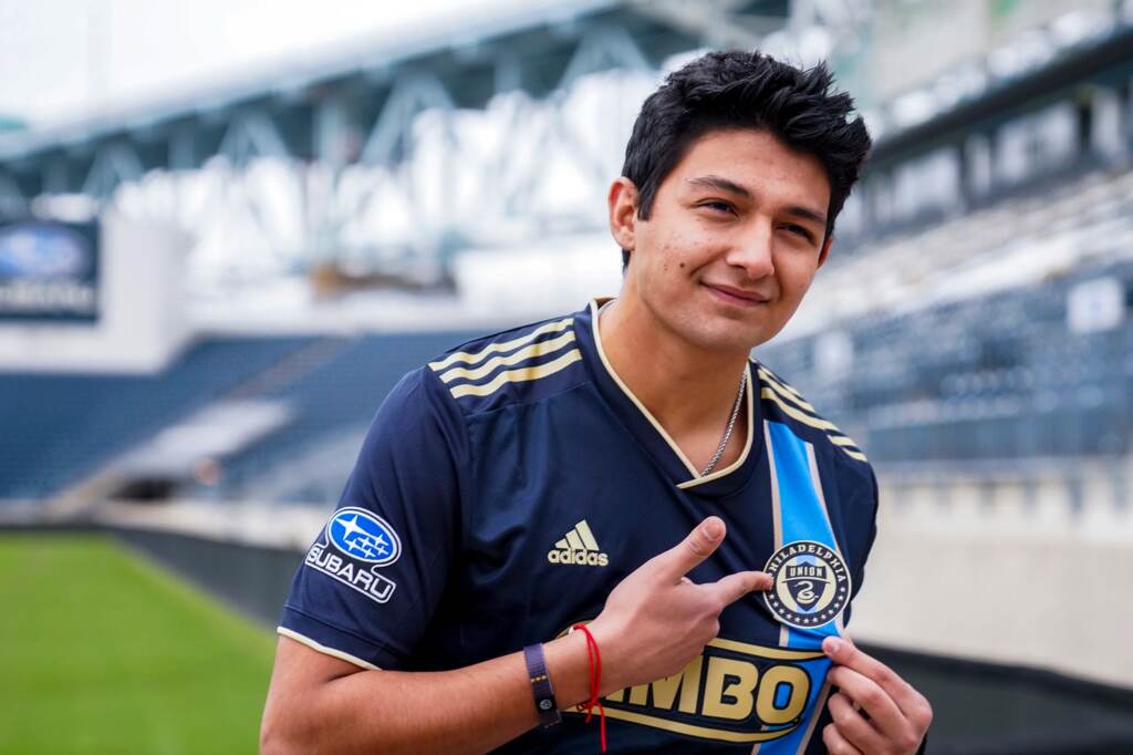 Thiago Vazquez on the field at Subaru Park Thiago Vazquez points to the Philadelphia Union badge on his shirt during his signing day
