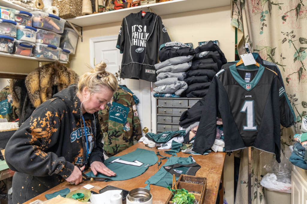 Nicole Styer, owner of the NRS Boutique in South Philadelphia, creates a corset for a client out of an Eagles Jersey to be sent to Arizona for the Super Bowl. (Kimberly Paynter/WHYY)