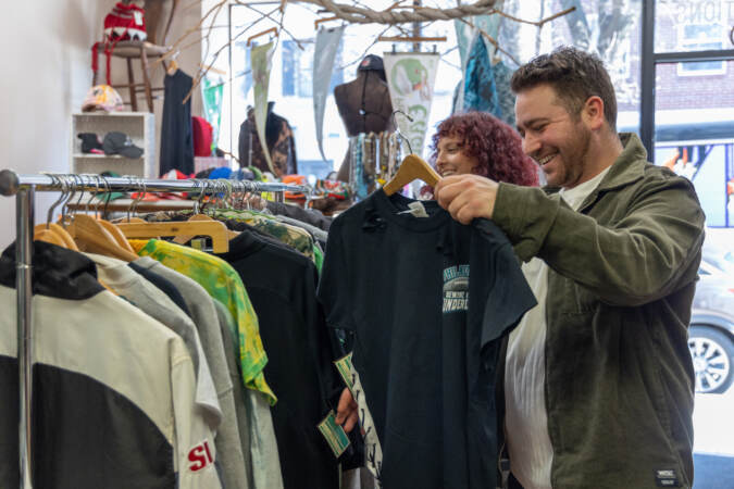 Eagles fans browse the selections at NRS Boutique in South Philadelphia ahead of the team’s appearance in Super Bowl LVII. (Kimberly Paynter/WHYY)