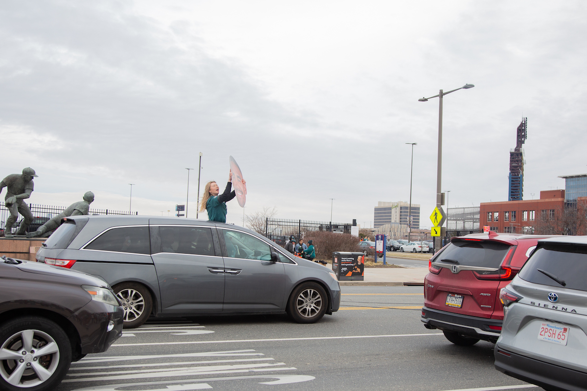 An Eagles fan drives up and down Pattinson Ave. with a large cut out of Eagles quarterback Jalen Hurts. (Emily Cohen for WHYY)