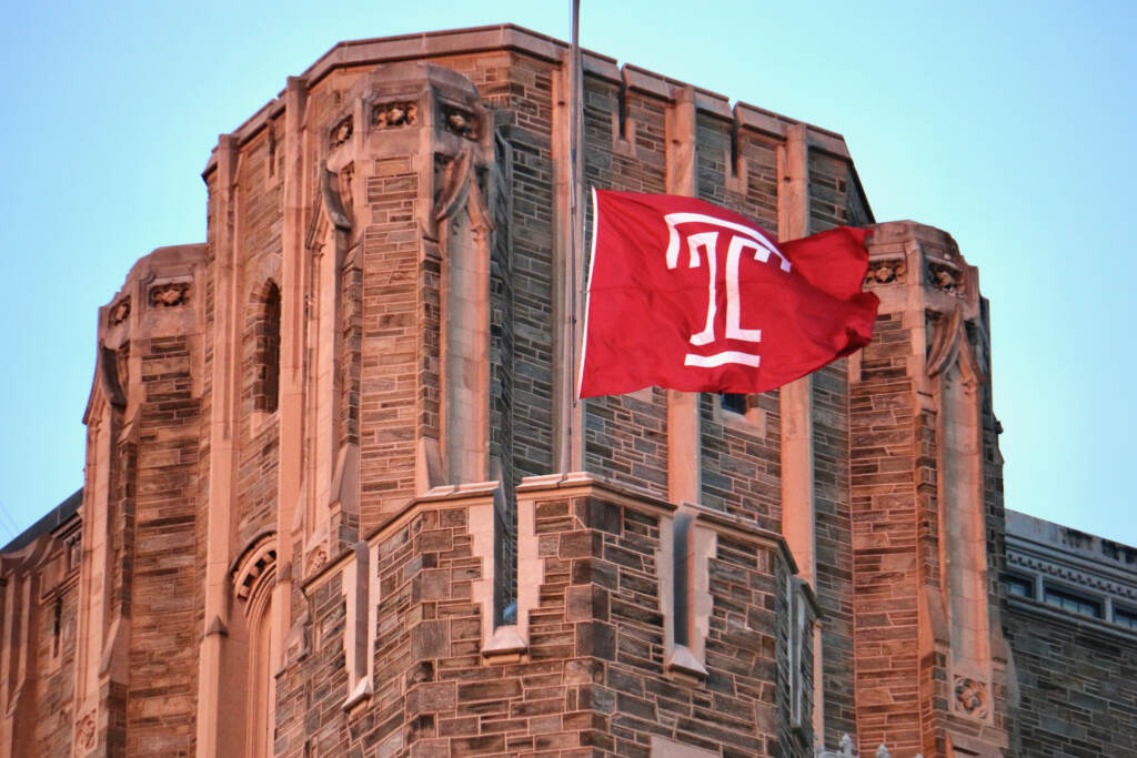 A flag bearing Temple University's logo flies at half-staff.