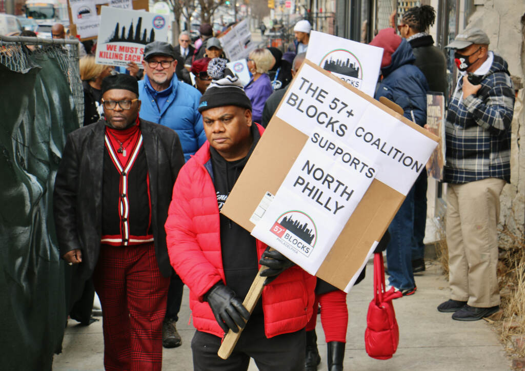 2023 02 27-e lee-rueben jones-philadelphia north broad and susquehanna-anti gun violence meeting and march sign Rueben Jones of Frontline Dads leads a march against gun violence through the streets of North Philadelphia. (Emma Lee/WHYY)