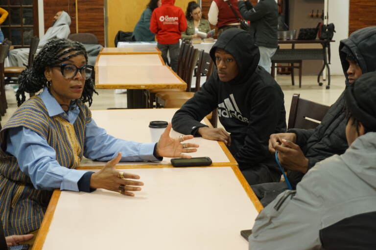 Kenyetta Overton, the director of the Murals of the Mind Project, talks to attendees