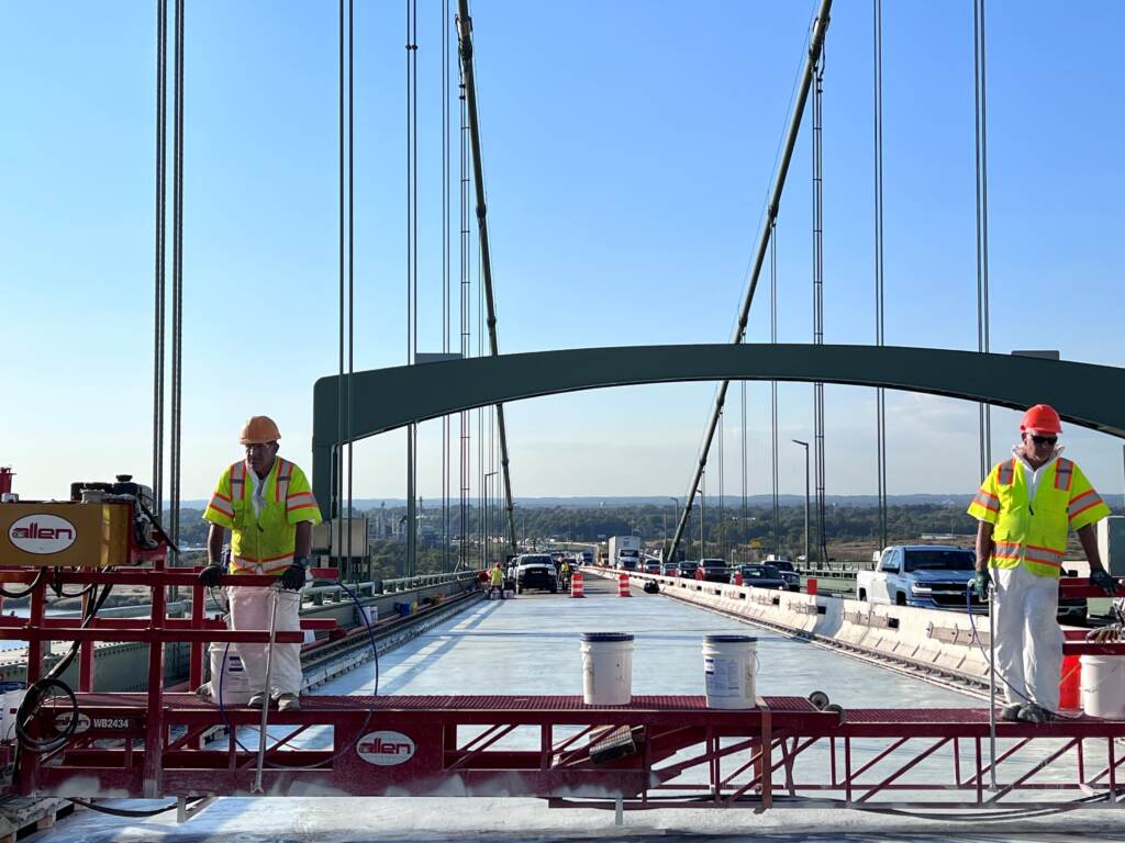 Workers pour ultra-high-performance concrete along the New Jersey-bound span of the Delaware Memorial Bridge during last year's phase one of the project