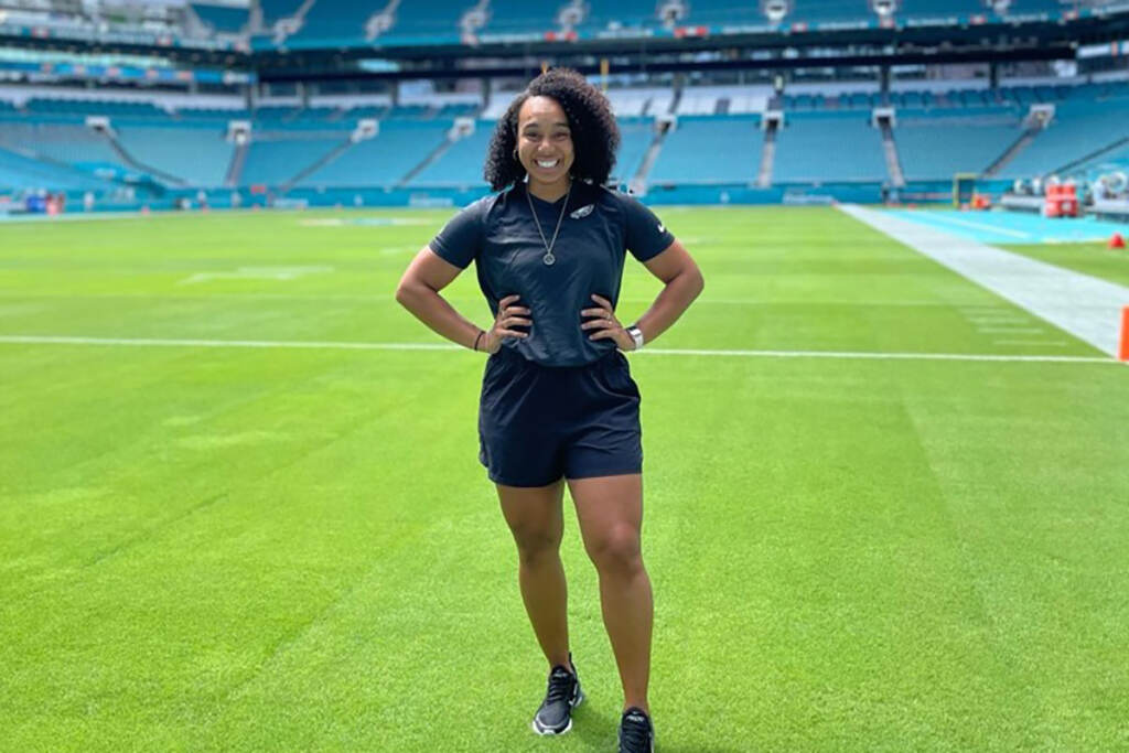 Autumn Lockwood stands on a football field.