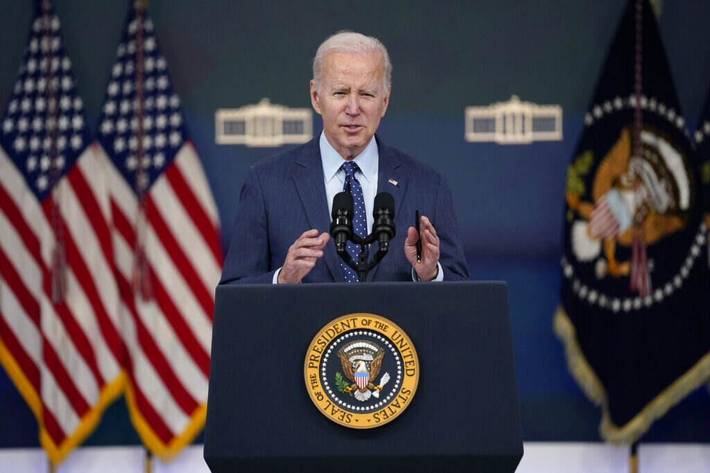 Biden Biden speaks from a podium.