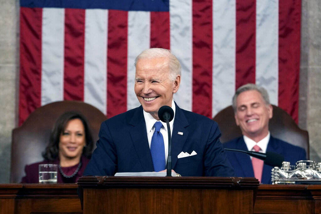 State of the Union Biden smiles, as Vice President Kamala Harris and Speaker of the House Kevin McCarthy smile behind him.