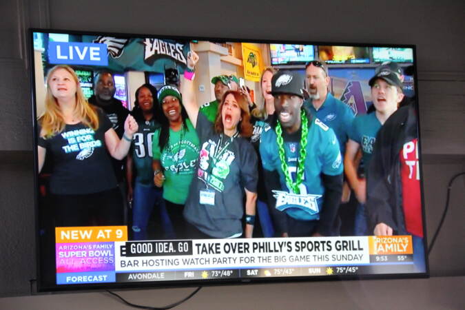 Channel 3 in Phoenix went live from Philly's Sports Grill to showcase the diehard Eagles fan club based in the area. (Cory Sharber/WHYY)