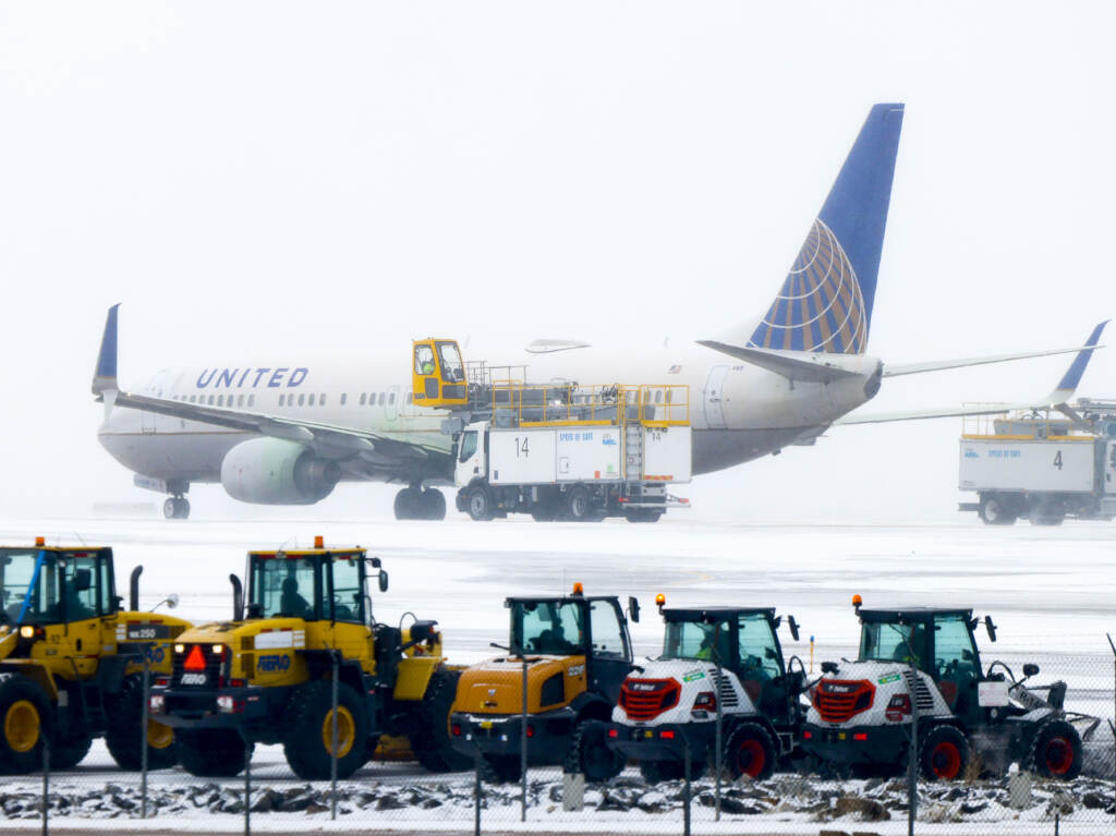 A United Airlines flight is de-iced before takeoff during a winter storm at Denver International Airport on Wednesday in Denver. A United Airlines flight is de-iced before takeoff during a winter storm at Denver International Airport on Wednesday in Denve