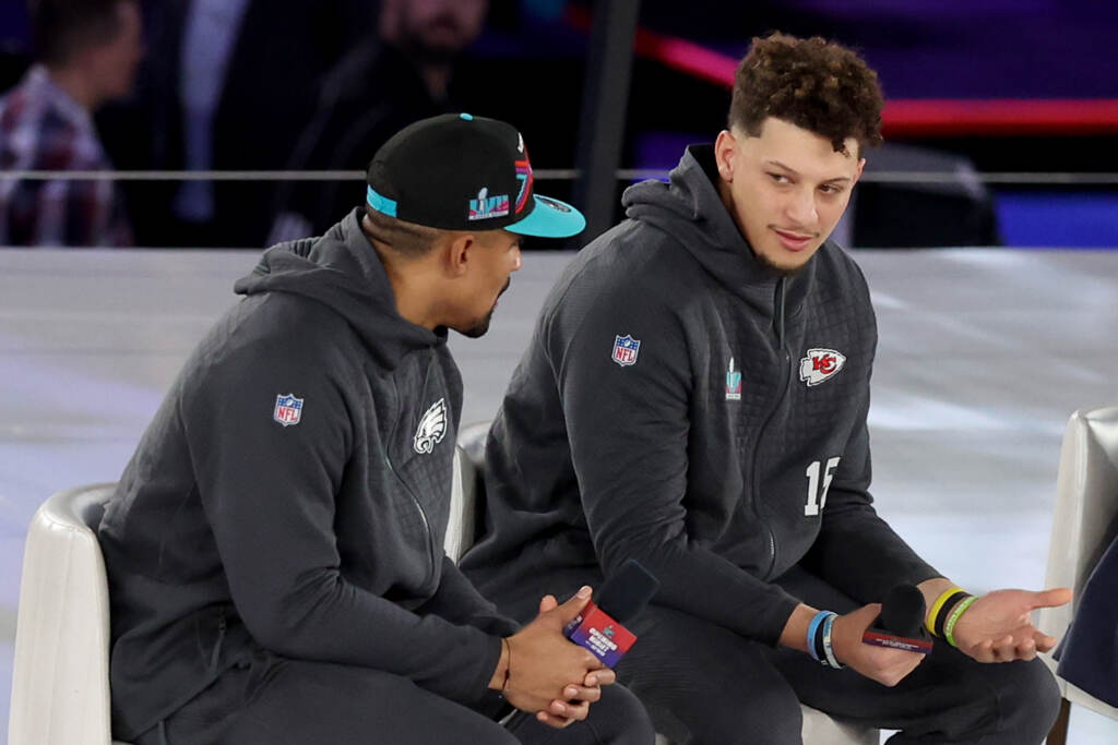 Jalen Hurts (left) of the Philadelphia Eagles talks with Patrick Mahomes of the Kansas City Chiefs during Super Bowl LVII Opening Night at Footprint Center on Monday in Phoenix. Mahomes and Hurts sit side by side onstage.