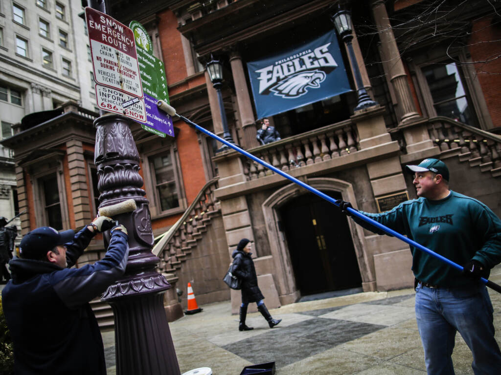 People use poles to apply grease to city poles